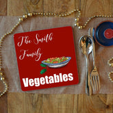 a personalised Christmas placemat with vegetables on and the words "the Smith family vegetables"